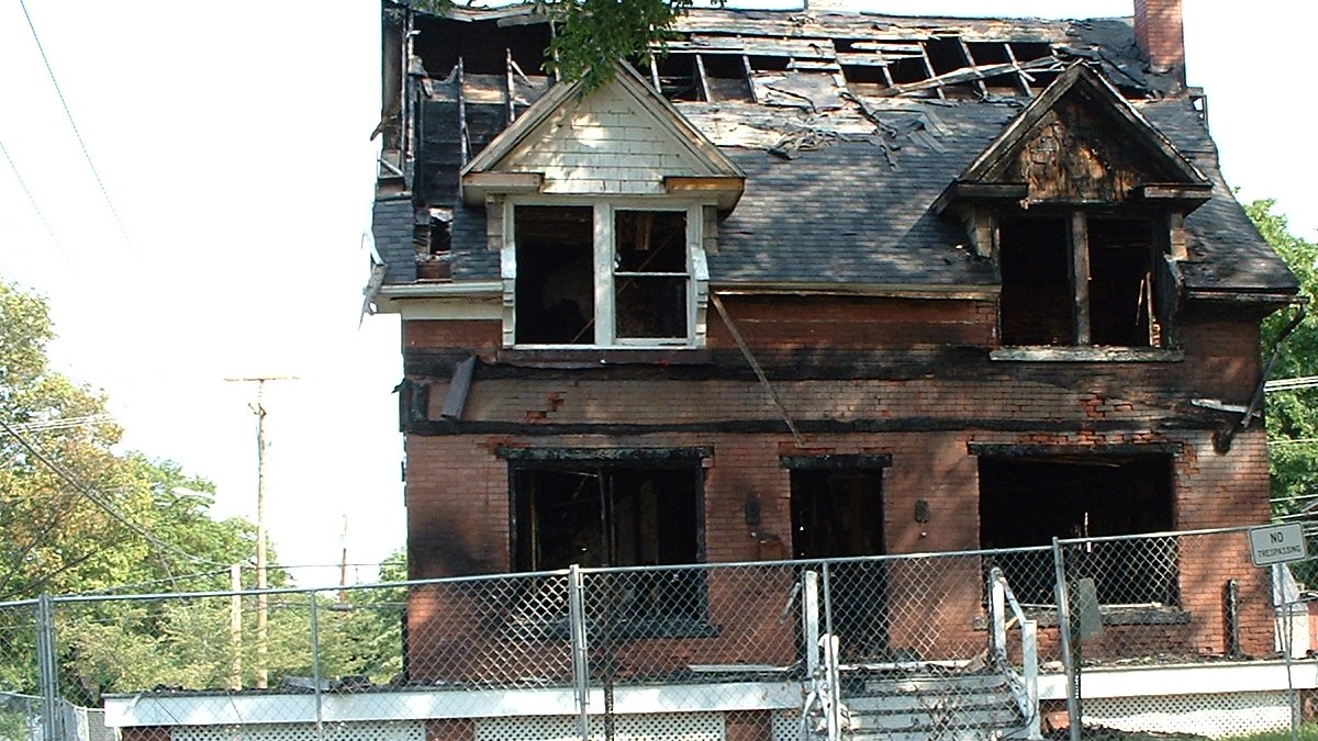 Ontario detached home with visible exterior fire and smoke damage on the front siding.