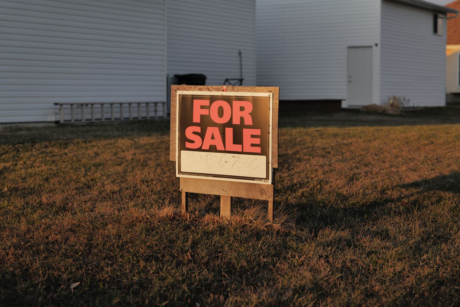 Ontario home with a for sale sign on a residential street.